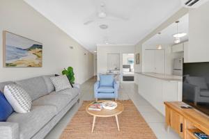 a living room with a couch and a table at Trinity Beach Retreat with Pool and Scenic Views in Trinity Beach +15 photos