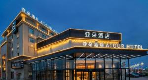 ein Gebäude mit einem Schild für ein Hotel in der Unterkunft Atour Hotel Nanchang Longding Chadu East Jiefang Road in Nanchang