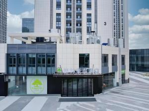 un bâtiment avec des tables et des chaises au-dessus dans l'établissement GreenTree Inn Jinan West Station Exhibition Center, à Jinan