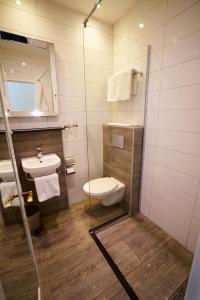 La salle de bains est pourvue de toilettes, d'un lavabo et d'un miroir. dans l'établissement Hotel The Bird, à Amsterdam
