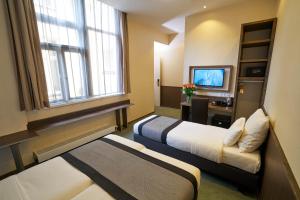 Ένα ή περισσότερα κρεβάτια σε δωμάτιο στο Hotel The Bird