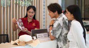 three women standing around a table with a woman looking at a laptop at Analynn Hotel in Ban Kohong +106 photos