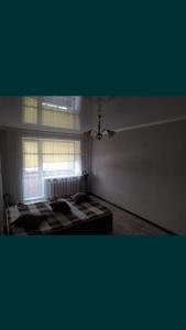 Ένα ή περισσότερα κρεβάτια σε δωμάτιο στο Елемесова 45