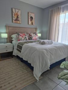 a bedroom with a large bed and a window at Mlangeni's Rest in Centurion