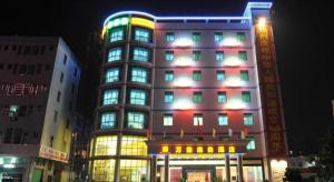 a tall building with many windows at night at Wanxiang Hotel in Maluan