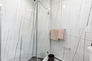 a shower with a glass door in a bathroom at Hamilton in Harrison +13 photos