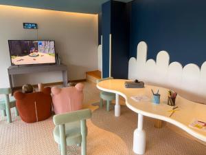 a play room with two tables and a tv at Sunshine Layan Beach Resort 2 bedroom #84192 in Layan Beach