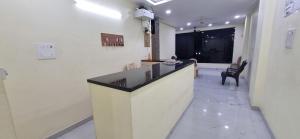 a lobby with a reception desk and a chair at Sri Srinivasa Lodge in Mārkāpur