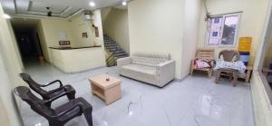 a living room with chairs and a couch and a table at Sri Srinivasa Lodge in Mārkāpur +1 photo