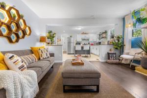 a living room with a couch and a table at *Super close to Hospitals|UAB|Open fl plan|2 bdr in Birmingham