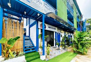 a blue building with plants in front of it at RedDoorz at Tandikan Suites El Nido in El Nido +19 photos