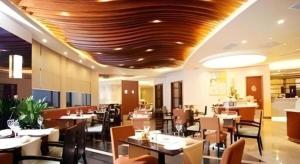 a dining room with tables and chairs in a restaurant at Ramada by Wyndham Wujiaochang Shanghai in Shanghai