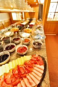 a buffet of food with cheese and meats on a counter at Pension Waldwinkel in Lenzkirch