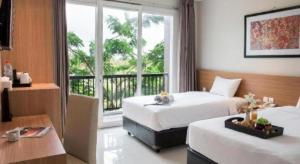 a hotel room with two beds and a window at D'Season Premiere Hotel in Kesembu +190 photos