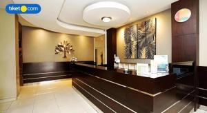 a lobby of a hotel with a reception desk at dPalma Hotel in Bandung