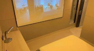 une salle de bain avec un lavabo et un miroir et des toilettes dans l'établissement Jinjiang Inn Wuhan Huanghelou Fuxing Road Metro Station, à Wuhan 12 autres photos