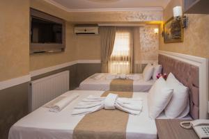 two beds in a hotel room with towels on them at Hotel Bestur in Istanbul