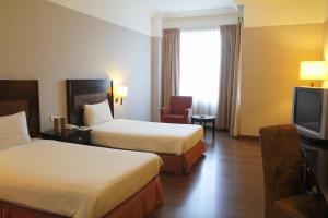 Postel nebo postele na pokoji v ubytování Grand Kampar Hotel