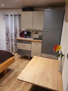 a small kitchen with a table and a refrigerator at Apartment Altenhof in Altenhof