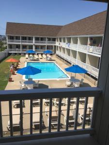 a view of the pool from the balcony of a hotel at Apartment in Royal Atlantic Beach Resort in Montauk