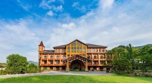 un grand bâtiment avec une tour au sommet d'un champ dans l'établissement Beijng Chestnut Valley Hotel, à Sanduhe