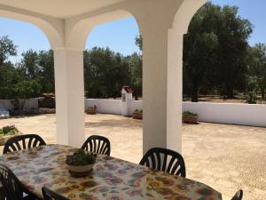 a table and chairs sitting on a patio at Trullo L'ulivo in Ostuni