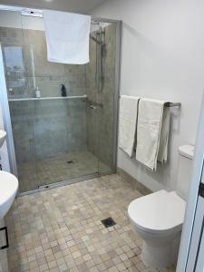 a bathroom with a shower and a toilet at Bluewater Haven in Buddina