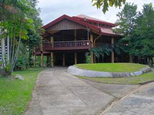 a house with a walkway in front of it at RiverCoves Resorts in Bulakan