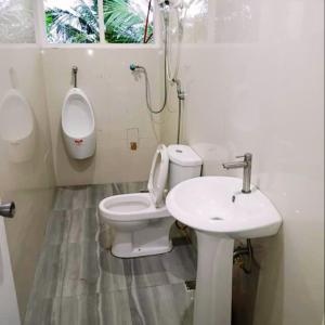 a bathroom with a toilet and a sink at RiverCoves Resorts in Bulakan +65 photos