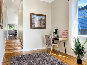 a home office with a desk and a chair at 3-Bed Coastal Haven with Alfresco Dining & BBQ in Marks Point +23 photos