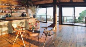 a room with a bar with chairs and a table at Mango House - Seaview - Homestay. in Lai Sơn