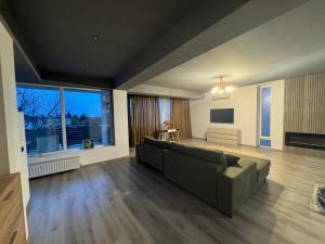 a living room with a couch and a flat screen tv at Casablanca Residence B in Cârcea