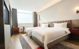 a bedroom with a large white bed and a window at W9-Hotel ShangHai PuDong Ariport in Shanghai +39 photos