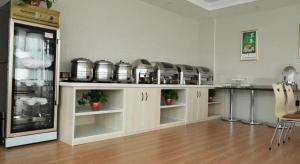 a kitchen with a bunch of pots and pans at GreeTree Inn Huainan Jinjialing Road Oriental General Hospital in Huainan