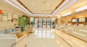 a waiting room at a hospital with couches and a counter at GreeTree Inn Huainan Jinjialing Road Oriental General Hospital in Huainan