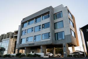 an office building with a gray building at Hygge Hotel in Seogwipo