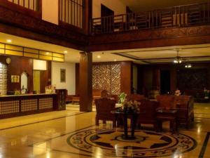 a lobby with a table and chairs in a building at Xishuangbanna Hotel Managed by Xandria Hotel in Ban Nongkham +223 photos