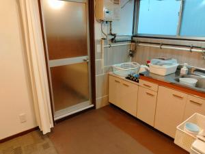 a kitchen with a sink and a shower at 波除ハイツ in Osaka +43 photos