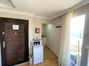 a small kitchen with a refrigerator and a door at Kuzguncuk View in Istanbul