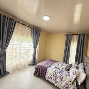 a bedroom with a bed and a window at Rest Haven Apartments Meanwood in Lusaka