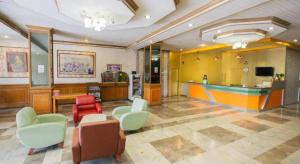 a lobby with chairs and a bar in a building at Lake Inn Hotel in Songkhla