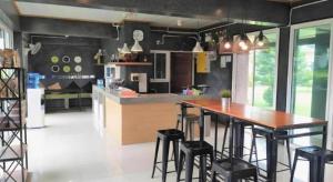 a kitchen with a wooden table and some stools at Loft Village in Ban Khlong Kathon +129 photos