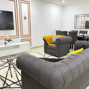 a living room with a couch and a tv at Rest Haven Apartments Meanwood in Lusaka