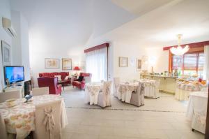 a dining room with tables and chairs with white table cloth at La Magnolia B&B in Campagna