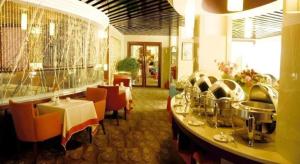 a dining room with a table and chairs in a restaurant at Lhasa Hotel in Lhasa