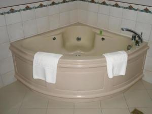 a bath tub with two towels in a bathroom at Batangas in Dilao +16 photos
