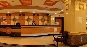 two people sitting at a bar in a lobby at Fujian Hotel in Beijing