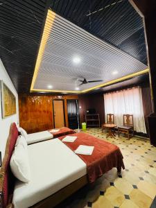 a bedroom with two beds in a room at Hotel caveri comfort in Madikeri