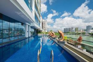 a swimming pool on the side of a building at Sanya Shuangda Adelaide In Resort Hotel in Sanya