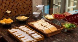 a table with a bunch of food on a table at Tong Da International Hotel in Zhangjiajie